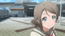 a girl in a school uniform is smiling in front of a building