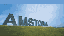 the word amstoria is on a grassy hill