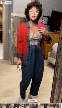 a woman taking a picture of herself in front of a mirror with hdr displayed