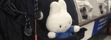 a stuffed bunny is sticking out of a backpack .