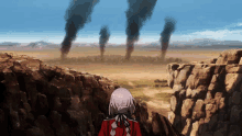 a woman in a red jacket stands on a rocky cliff overlooking a desert with smoke coming out of it