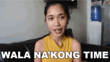 a woman in a yellow tank top is sitting on a couch with the words wala na kong time below her