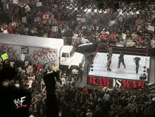 wrestlers in a wrestling ring with a coors light truck in the background