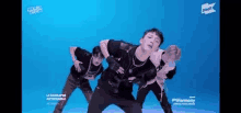 a group of young men are dancing together on a blue screen .