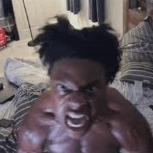 a shirtless man is sitting on a bed with his mouth open and making a funny face .