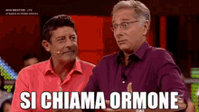 two men are sitting next to each other with the words si chiama ormone written in white letters