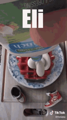 a bottle of eii dressing is being poured onto a waffle