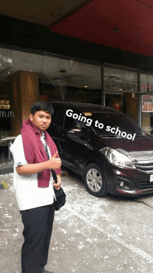 a man standing in front of a car that says going to school on it