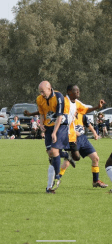 a man in a yellow and blue jersey with the number 9 on it