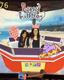 two women in a photo booth with a sign that says queen