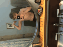 a man taking a picture of himself in the bathroom mirror