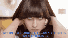 a woman with bangs is looking at the camera with the words get on board with latest trends through bang extensions below her