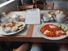 a table topped with plates of food and a menu that says ' stefan ' on it