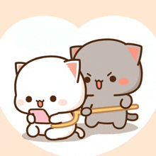 two cartoon cats are sitting next to each other in a heart . one of the cats is holding a cell phone .