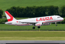 a lauda airplane is taking off from an airport