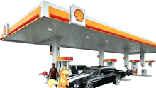 a shell gas station with a car parked underneath