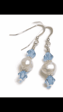 a pair of earrings with blue beads and pearls