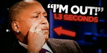 a man in a suit and tie is crying in front of a sign that says i 'm out 1.3 seconds .