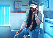 a man with long hair is talking on a phone while wearing a pepsi hat