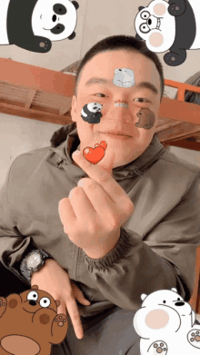 a man with panda bears on his face making a heart shape with his fingers