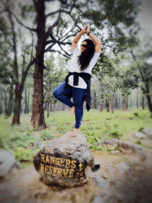 a woman stands on a rock that says ranger 's reserve