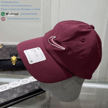 a maroon nike hat sits on a mannequin head