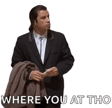 a man in a suit is holding a jacket and the words " where you at tho " are below him