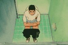 a man sits on a toilet with his pants down