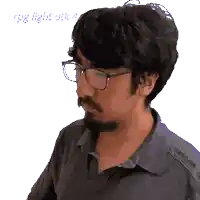 a man with glasses and a beard looks to the side