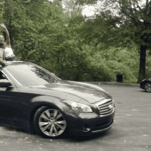 a woman stands on the roof of a car