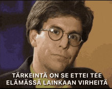 a man with glasses and the words " tarkenta on se ettei tee elamassa lainkaan virheita " on the bottom