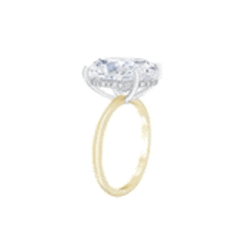 a yellow gold ring with a large diamond in the middle