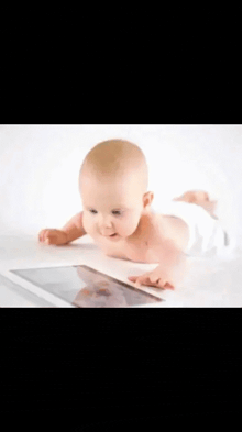 a baby in a diaper is playing with a tablet