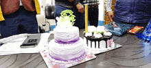 two cakes on a table with one that says ' happy birthday ' on top