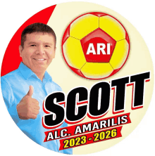 a man giving a thumbs up in front of a soccer ball with the name scott on it