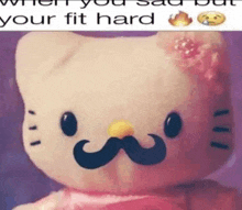 a hello kitty doll with a mustache on her face .