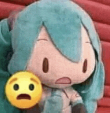 hatsune miku is holding a stuffed animal with a surprised face .