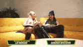 a man and a woman are sitting on a yellow couch and the man is a wwe tag team champion