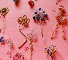 a bunch of wire crafts on a pink background