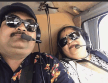 a man and woman wearing sunglasses and headphones