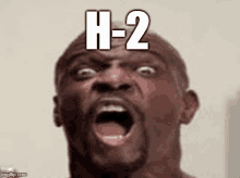 a man is making a funny face with his mouth open and the words h- 2 on his face