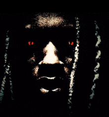 a close up of a person 's face with red eyes and dreadlocks