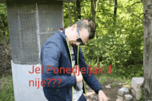 a man wearing sunglasses and a blue jacket with the words jel ponedjeljak ii nije written on it