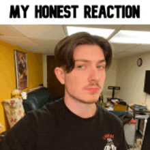 a young man is taking a selfie in a living room with the words my honest reaction above him