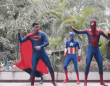 superman captain america and spider-man are dancing together outside