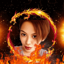 a woman in a circle of fire with a dragon in the background