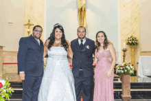 a bride and groom pose for a photo with their wedding party