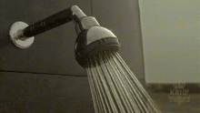 a shower head is spraying water on a wall .