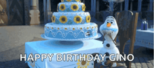 a birthday cake with sunflowers on it is on a table next to a stuffed snowman that says happy birthday gino