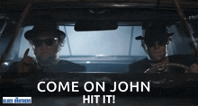 two men driving a car with the words come on john hit it on the bottom